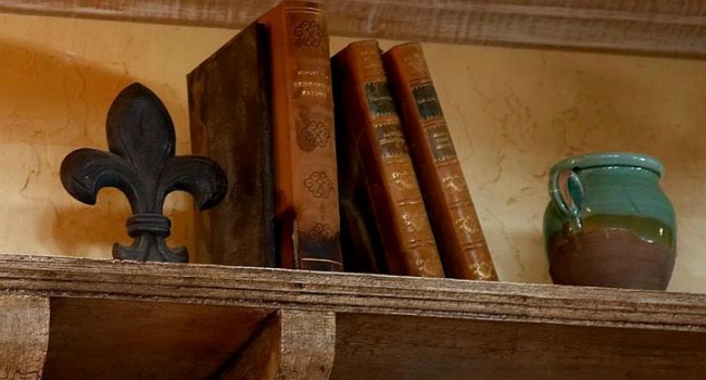 old books and a jug on a shelf