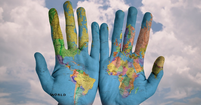 hands covered in map of the world