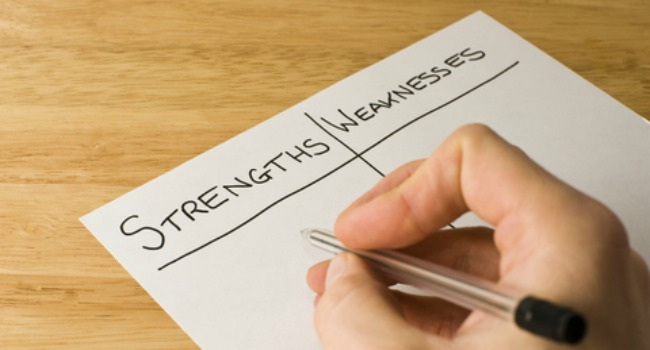 person writing strengths and weaknesses