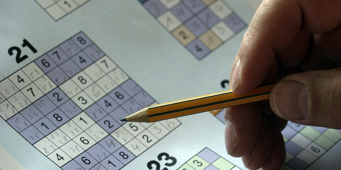 someone completing a sudoku puzzle